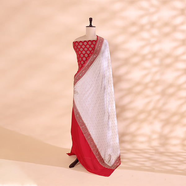 Complete unstitched festive suit set featuring a vibrant ruby red crepe silk fabric beautifully contrasted with a soft cream mist dupatta.