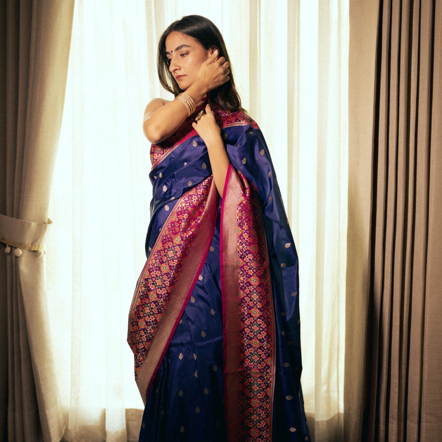 Handwoven Banarasi silk saree with Patola pallu and heavy border with contrast fuchsia blouse