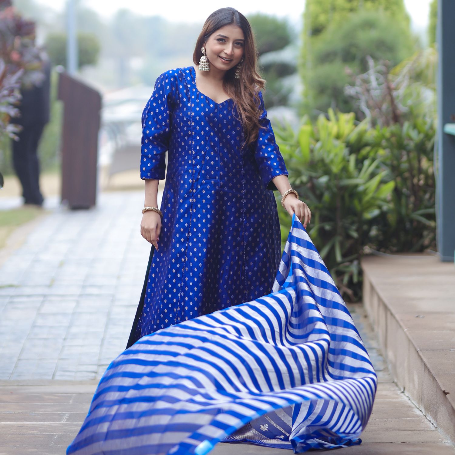 Showing the lightweight flow and drape of the blue organza tissue striped dupatta.