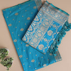 Close-up view of the premium aqua blue Banarasi silk fabric, highlighting the exquisite traditional neck pattern and fine handloom craftsmanship.