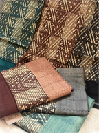 Close-up view of folded cotton fabrics with intricate geometric patterns and a branded Arzo tag.