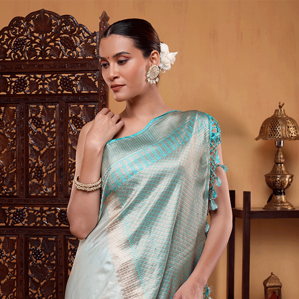 Close-up detail of the horizontal gold zari and resham border on the handwoven pure katan silk Aurora Borealis saree.