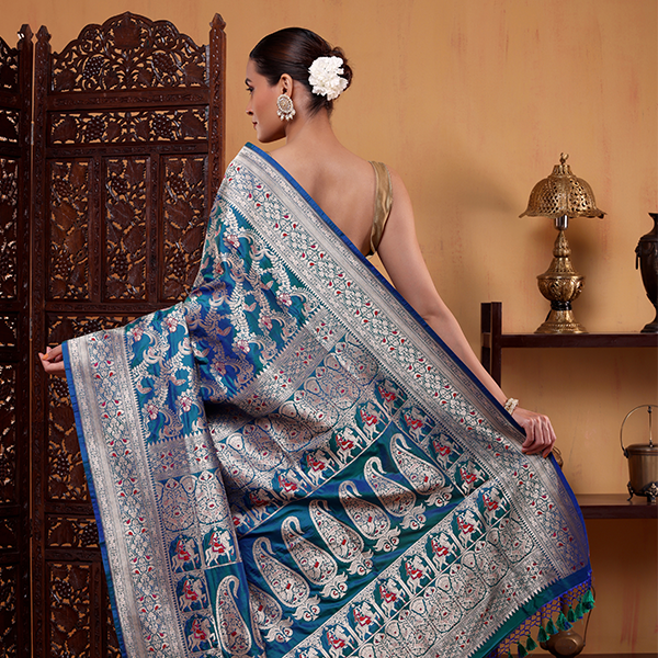 Intricate close-up view of the handwoven Shikargah Meenakari Jaal and detailed Zari work on the blue Katan silk saree.