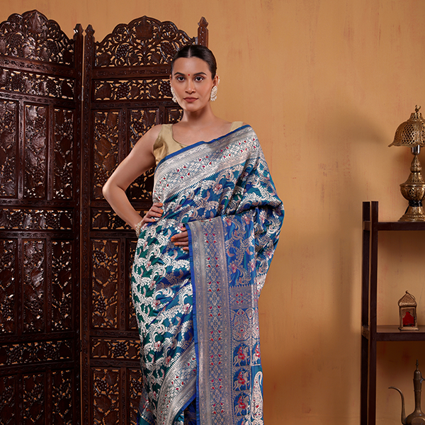 Unstitched blue silk blouse fabric with a matching handwoven Meenakari border included with the Katan silk saree.