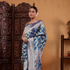 Close-up of the elegant Meenakari border featuring fine gold Zari and Resham embroidery on a premium blue base.