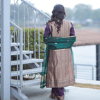 Back view of a grape purple Banarasi silk suit with vertical gold boota weaving and a green kora dupatta draped over the shoulders.