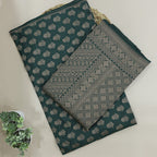 Close-up detail of the traditional full Jaal handwoven pattern on pure emerald green Jamawar silk fabric.