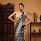 Detailed shot of the premium handloom Banarasi satin silk fabric highlighting its luxurious glossy texture and woven stripes.
