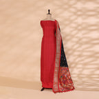 Flat lay presentation of the complete unstitched premium luxury suit set, including the strawberry blush Banarasi silk kurta fabric and slate grey Paithani dupatta.