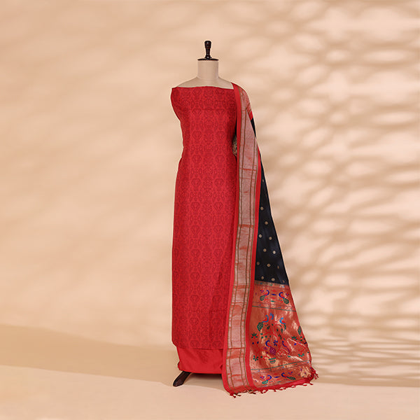 Flat lay presentation of the complete unstitched premium luxury suit set, including the strawberry blush Banarasi silk kurta fabric and slate grey Paithani dupatta.