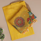 Close-up shot of the rich handwoven texture of the golden yellow Banarasi silk fabric alongside the intricate floral motifs on the Kalamkari organza dupatta.