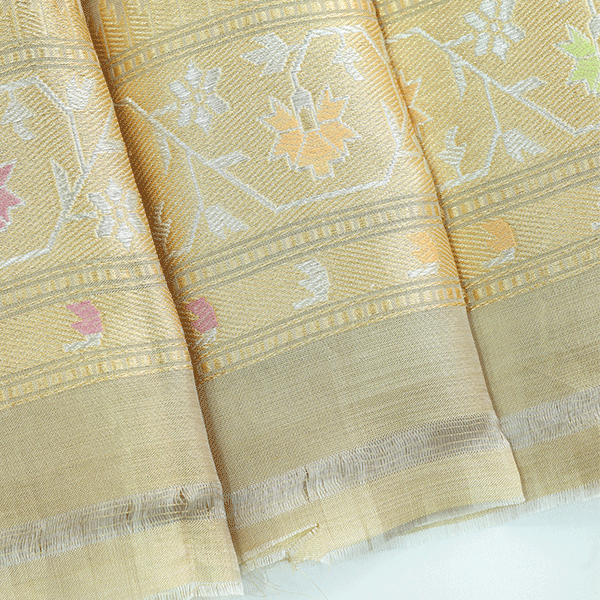 The premium finish and traditional craftsmanship on the pallu of the golden glow tissue silk saree, highlighted by beautiful decorative tassels.