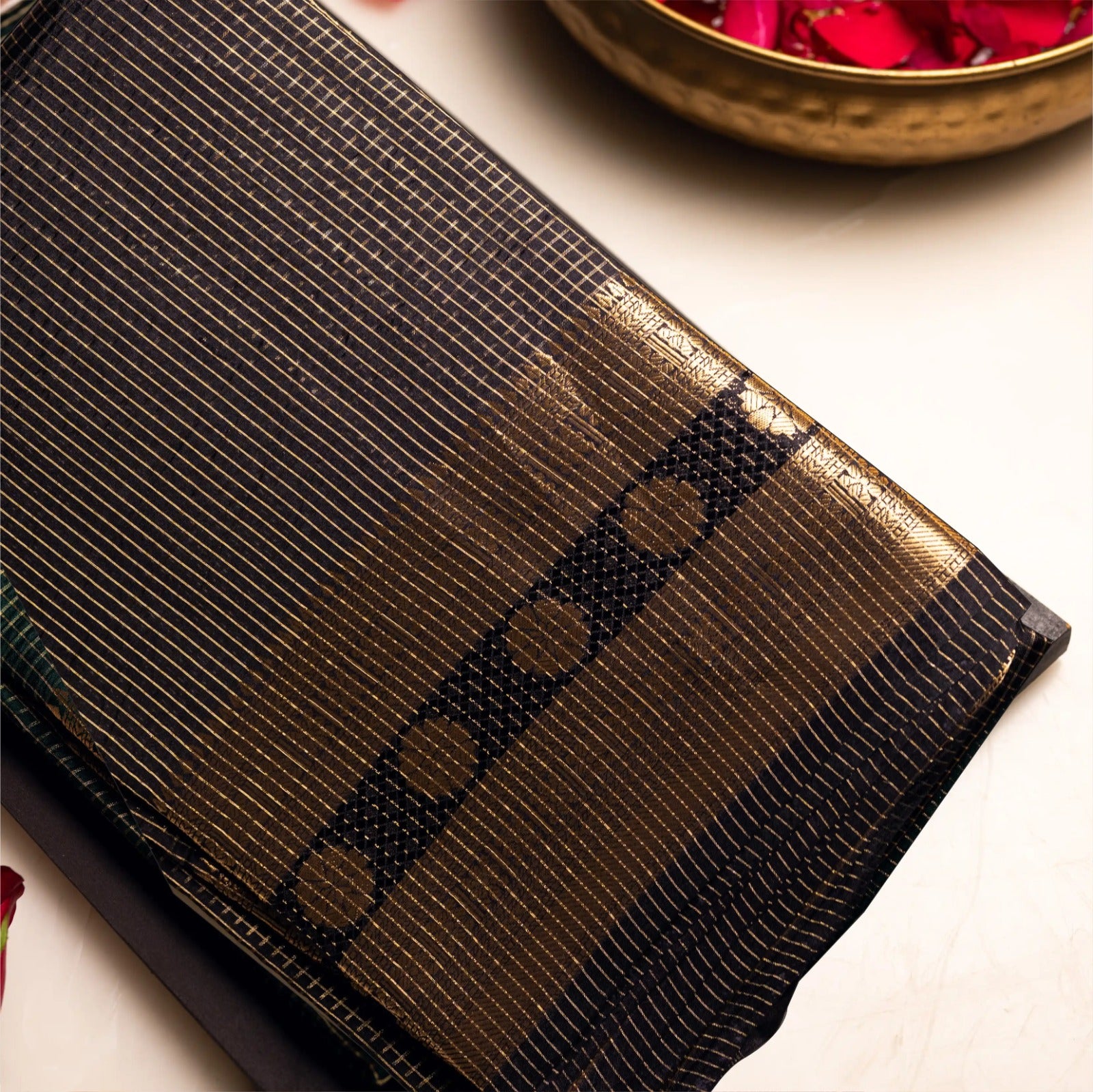 Detailed close-up of the black Handwoven Pure Katan Silk Saree showing the metallic gold zari check pattern and floral border.