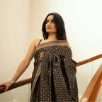 Side view of a Black Handwoven Katan Silk Saree showing the elegant drape and detailed gold zari geometric patterns.