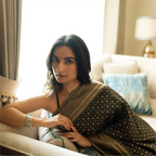Portrait of a model wearing a Black Handwoven Katan Silk Saree, showcasing the intricate diamond-patterned zari work and high-quality silk texture.