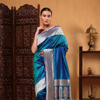 Detailed view of the vibrant Meenakari four-sided gold zari border on the handwoven blue azure katan silk saree.