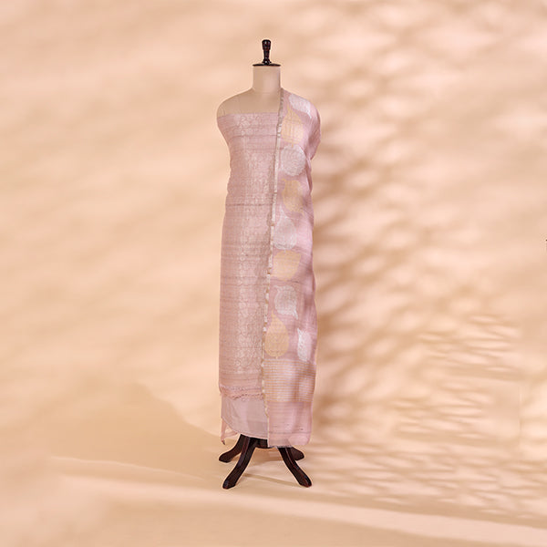 Blush pink handwoven Banarasi crushed georgette suit with intricate Zari work and a leaf pattern dupatta displayed on a mannequin.