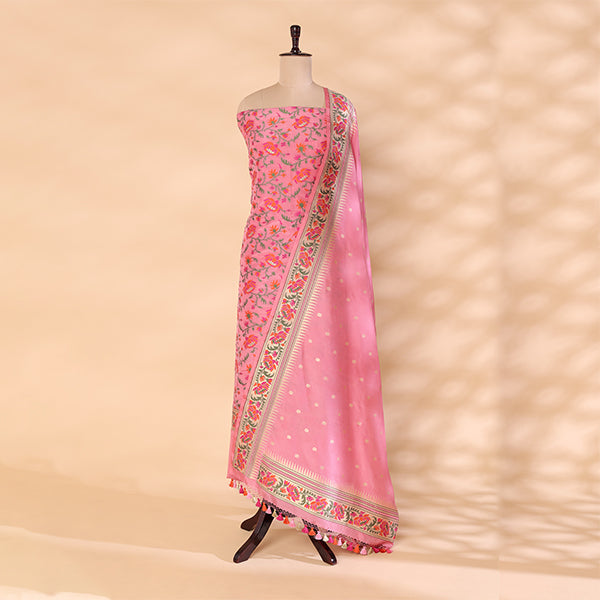 A traditional Banarasi Katan silk suit in soft blush pink, featuring intricate Resham and Zari detailing, elegantly displayed on a mannequin.