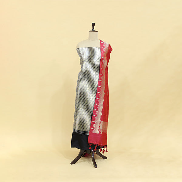Burgundy Radiance unstitched suit fabric in handwoven brocade satin silk with elegant black and white stripes on a mannequin, paired with a radiant red full zari jaal dupatta.