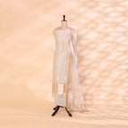 A mannequin displaying a serene cloud-grey handwoven organza silk suit, featuring delicate gold and silver zari work and an elegant matching dupatta.