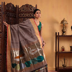 Front drape view of the Coffee Elegance silk saree highlighting the handwoven pleat structure and the rich contrasting zari border.