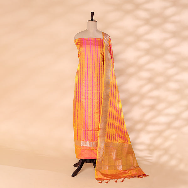 Copper Radiance unstitched suit fabric in handwoven satin silk with a radiant copper yellow shade and pink resham strips, paired with a matching silver border dupatta on a mannequin.