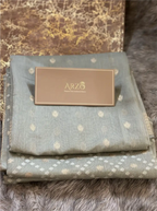 Close-up texture view of the premium breathable gray cotton suit fabric, showcasing the fine handloom style weave and pattern details.