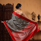 Front drape view of the Crimson Majesty silk saree highlighting the clean handwoven black and white satin stripes.
