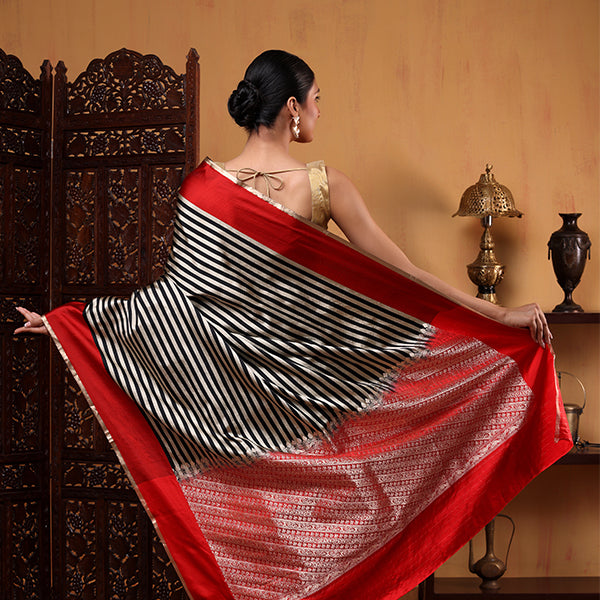 Front drape view of the Crimson Majesty silk saree highlighting the clean handwoven black and white satin stripes.