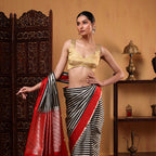 Detailed view of the elegant crimson red satin saree pallu featuring delicate matching tassels and traditional Banarasi borders.