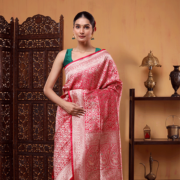Detailed view of the heavy gold zari pallu on the Crimson Shikargah Splendor Katan silk saree, highlighting its regal look.