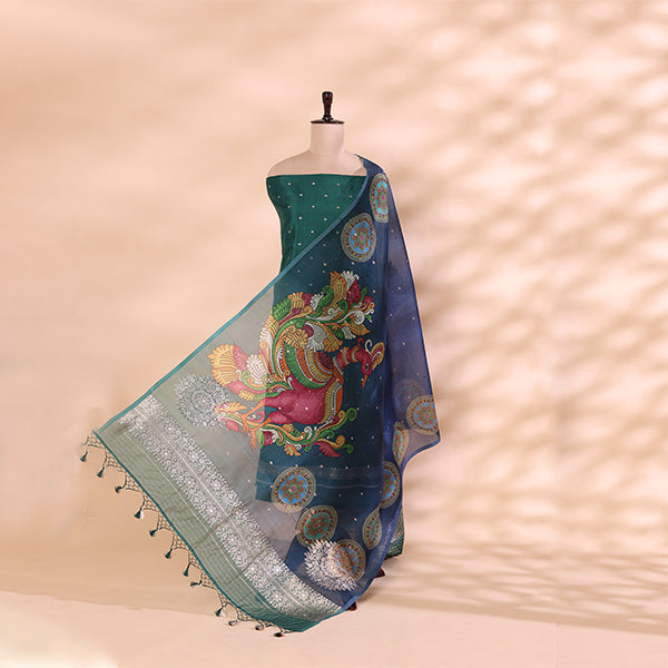 A mannequin draped in luxurious deep blue pure Banarasi silk fabric, detailed with vibrant, multi-colored handwoven peacock motifs and intricate gold zari border work.