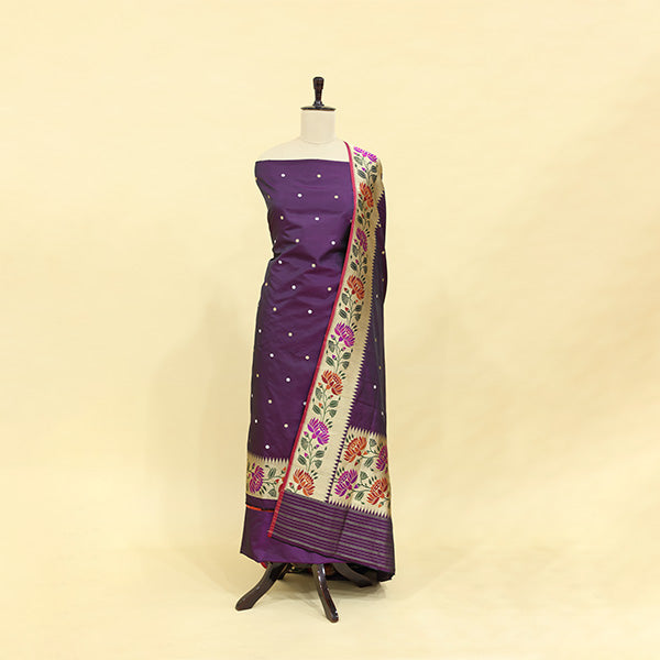 A handwoven Katan silk suit with a deep orchid matte base and a vibrant twilight spectrum dupatta, featuring a traditional Paithani border, displayed on a mannequin