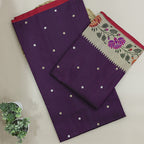 A beautiful flat-lay of a deep purple unstitched Banarasi silk suit fabric, featuring elegant gold zari bootis and a contrasting traditional floral border pattern