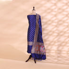 Elegant drape of the electric blue Banarasi silk suit fabric and dupatta emphasizing the grand traditional borders and luxury texture.
