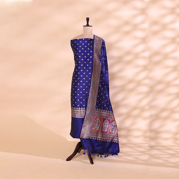 Elegant drape of the electric blue Banarasi silk suit fabric and dupatta emphasizing the grand traditional borders and luxury texture.