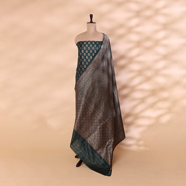 Elegant drape of the Enchanted Emerald Banarasi silk suit fabric highlighting the luxury texture and gold zari borders.