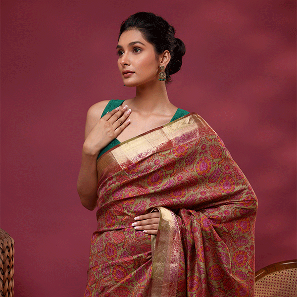 Model wearing the Enchanted Aurora Silk Saree made of pure China silk featuring twilight purple and gold digital prints with a green sleeveless blouse.