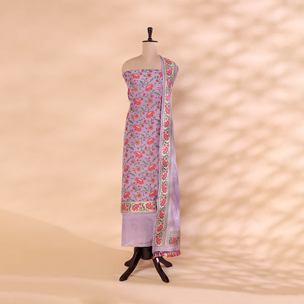 Enchanted Lilac Handwoven Banarasi Katan Silk Suit material draped on a mannequin, showcasing delicate Resham and gold Zari thread weaving on a soft lilac canvas.