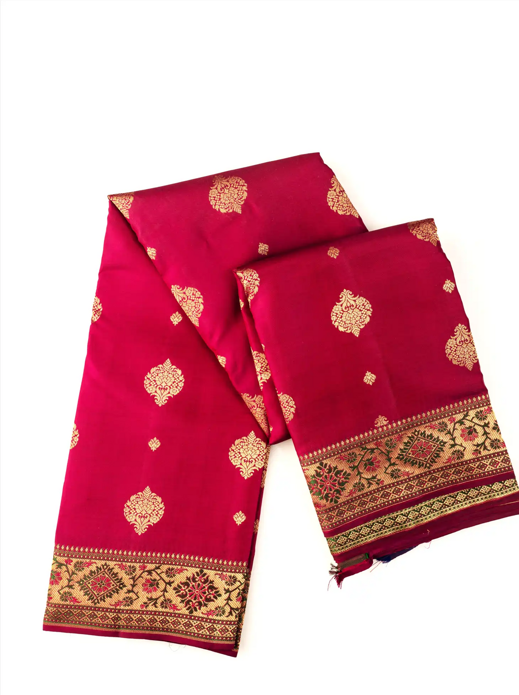 Neatly folded deep red pure silk Kanjivaram Paithani saree displaying gold zari floral motifs woven across the fabric, paired with an elaborate Paithani border featuring geometric zari patterns.