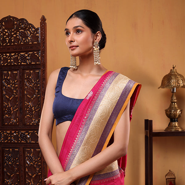 Close-up of the detailed handwoven resham zari work and multicolored sunset and purple border accents on the Fuchsia Blossom saree.