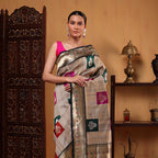 Detailed view of the luxurious heavy palla adorned with intricate multicoloured zari embroidery on the golden beige Tussar silk saree.