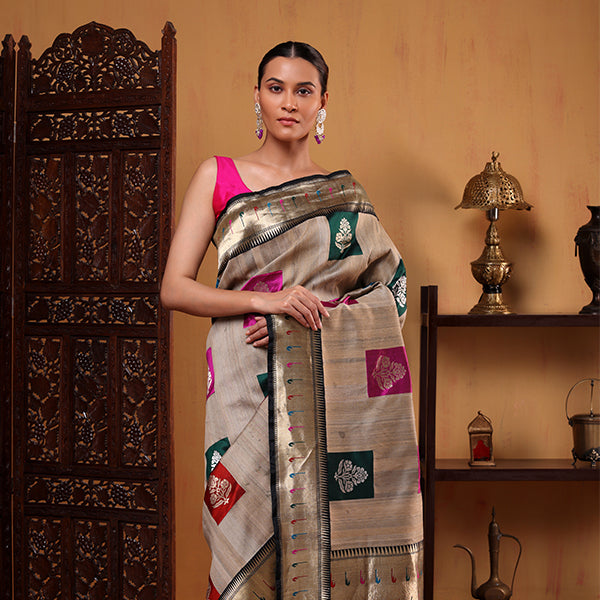 Detailed view of the luxurious heavy palla adorned with intricate multicoloured zari embroidery on the golden beige Tussar silk saree.