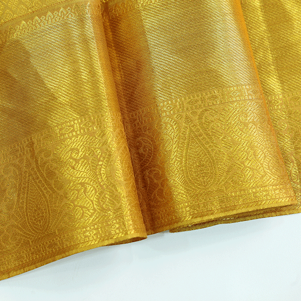 Back view of the golden mustard Kanjivaram silk saree drape, highlighting the elegant fall and rich texture of the handloom fabric.