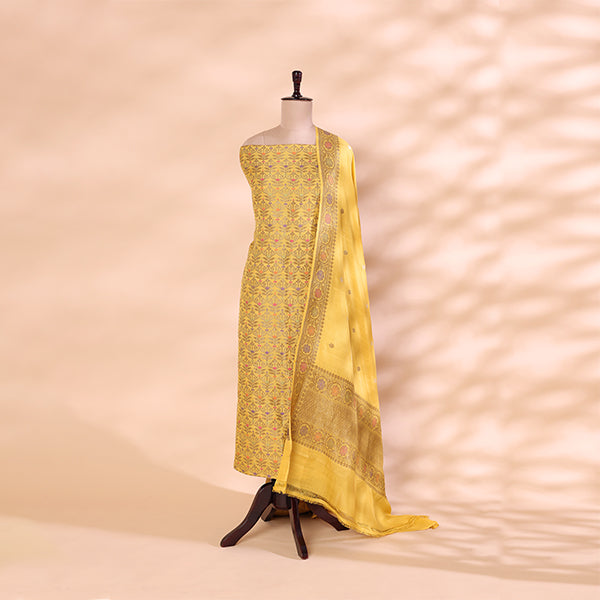Handwoven golden yellow Munga Silk suit with a radiant yellow and golden dupatta featuring intricate Zari and Resham work, displayed on a mannequin.