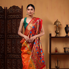 A side angle view of the Golden Sunset Paithani silk saree showcasing the vibrant red pallu intricately woven with traditional colorful peacock and floral motifs.