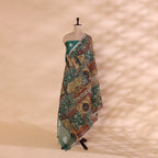 A mannequin displaying a sophisticated green unstitched Banarasi silk suit, paired with a vibrant, multi-colored traditional dupatta featuring intricate woven patterns.