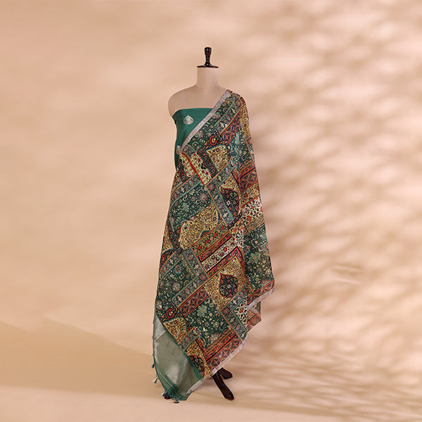 A mannequin displaying a sophisticated green unstitched Banarasi silk suit, paired with a vibrant, multi-colored traditional dupatta featuring intricate woven patterns.