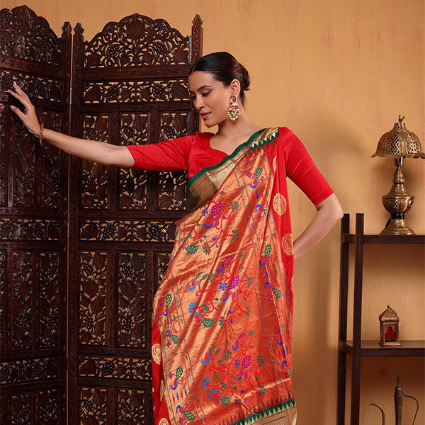Elegant draping of a pure Paithani silk saree in a vibrant blend of verdant green and radiant red.