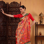Elegant draping of a pure Paithani silk saree in a vibrant blend of verdant green and radiant red.